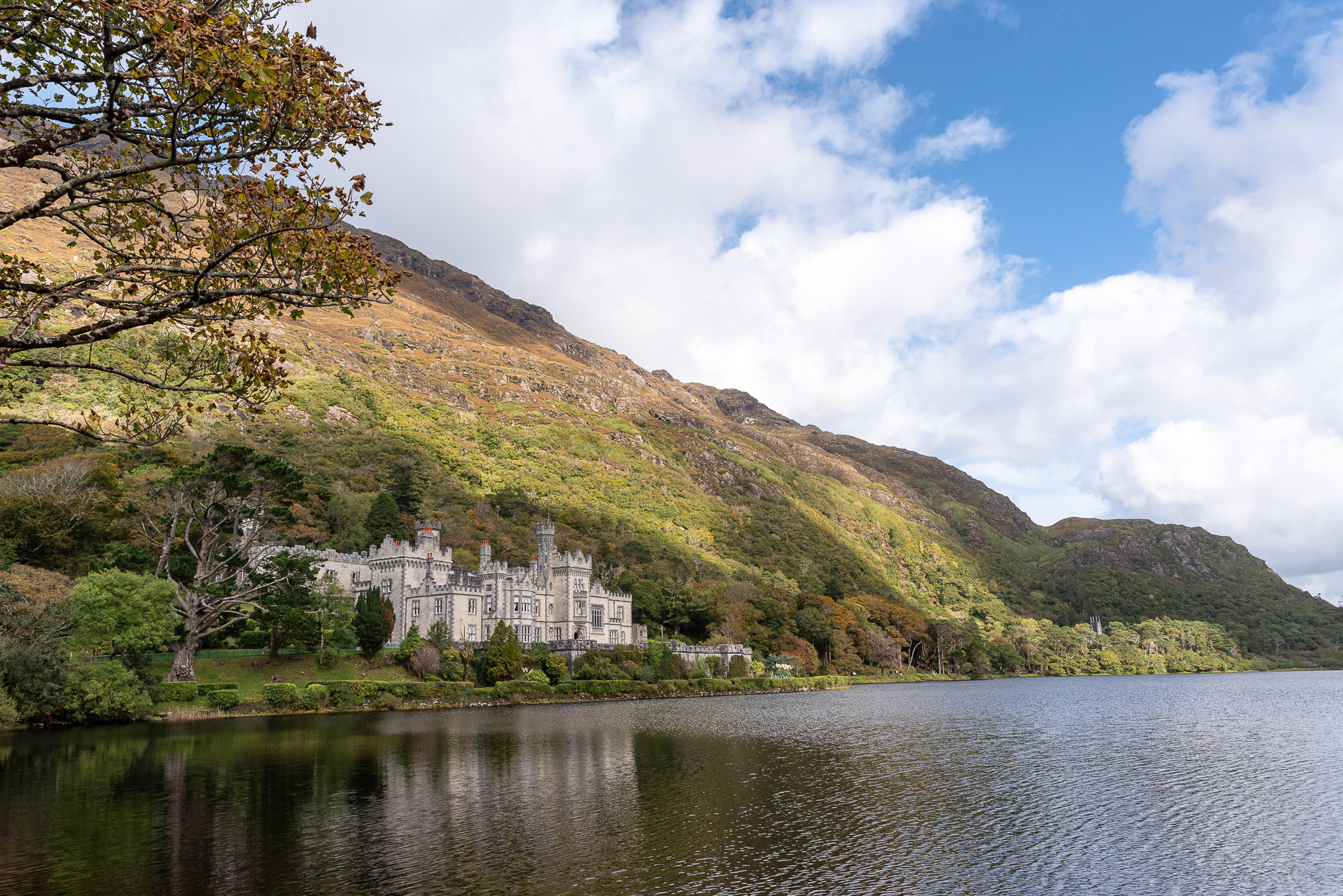 Kylemore Abbey on the shore of a lake beneath the Connemara mountains