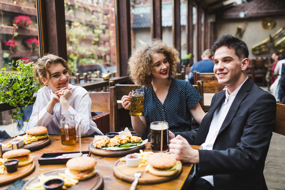 Friends enjoying burgers and drinks at a cosy pub