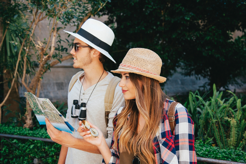 Couple exploring with a map, binoculars and compass