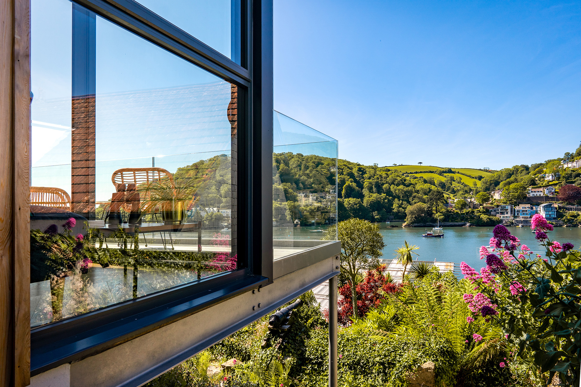 View of the river and hills from a glass balcony window