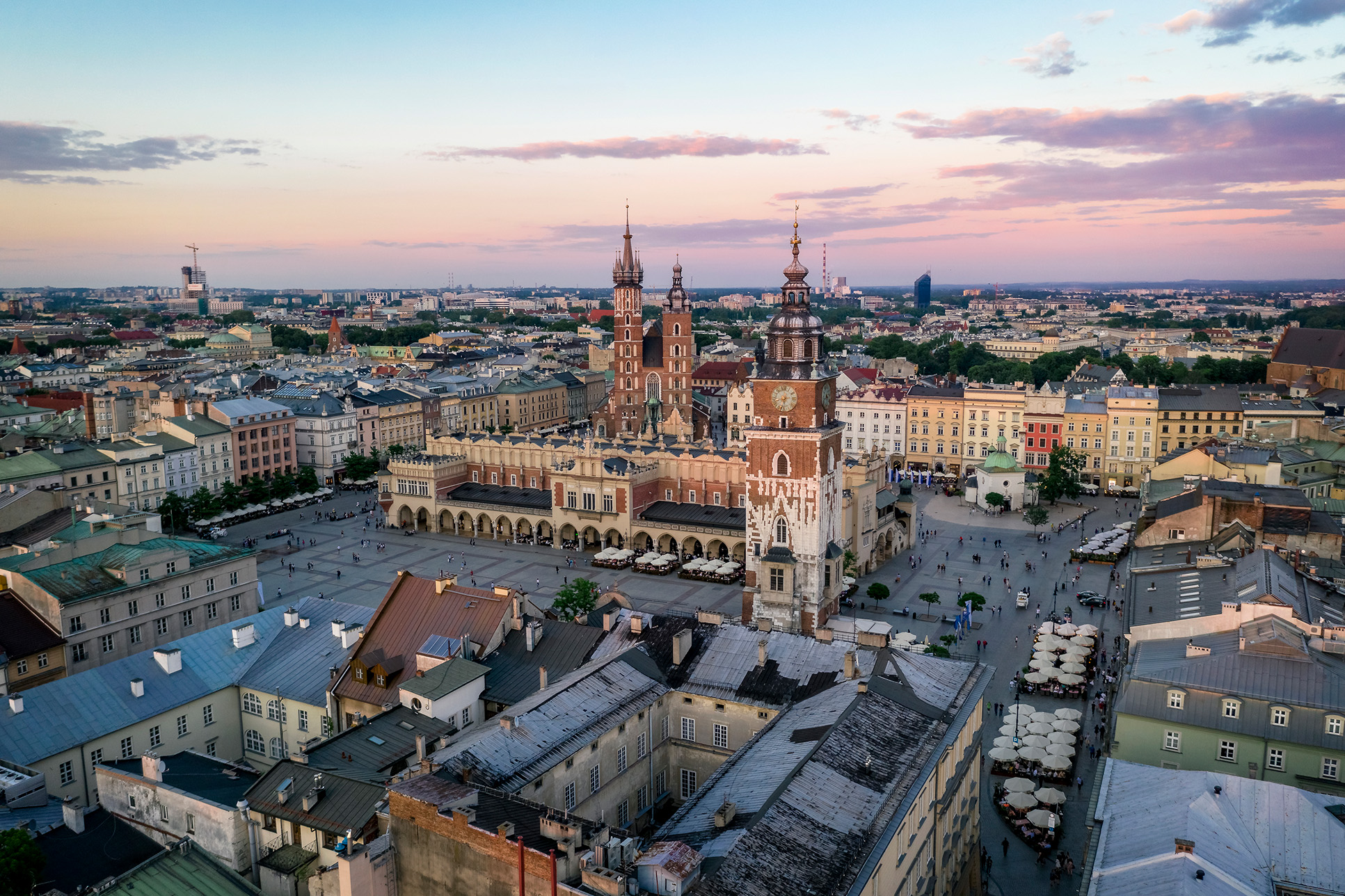 Aerial view of Kraków's Main Square at sunset with St. Mary's Basilica