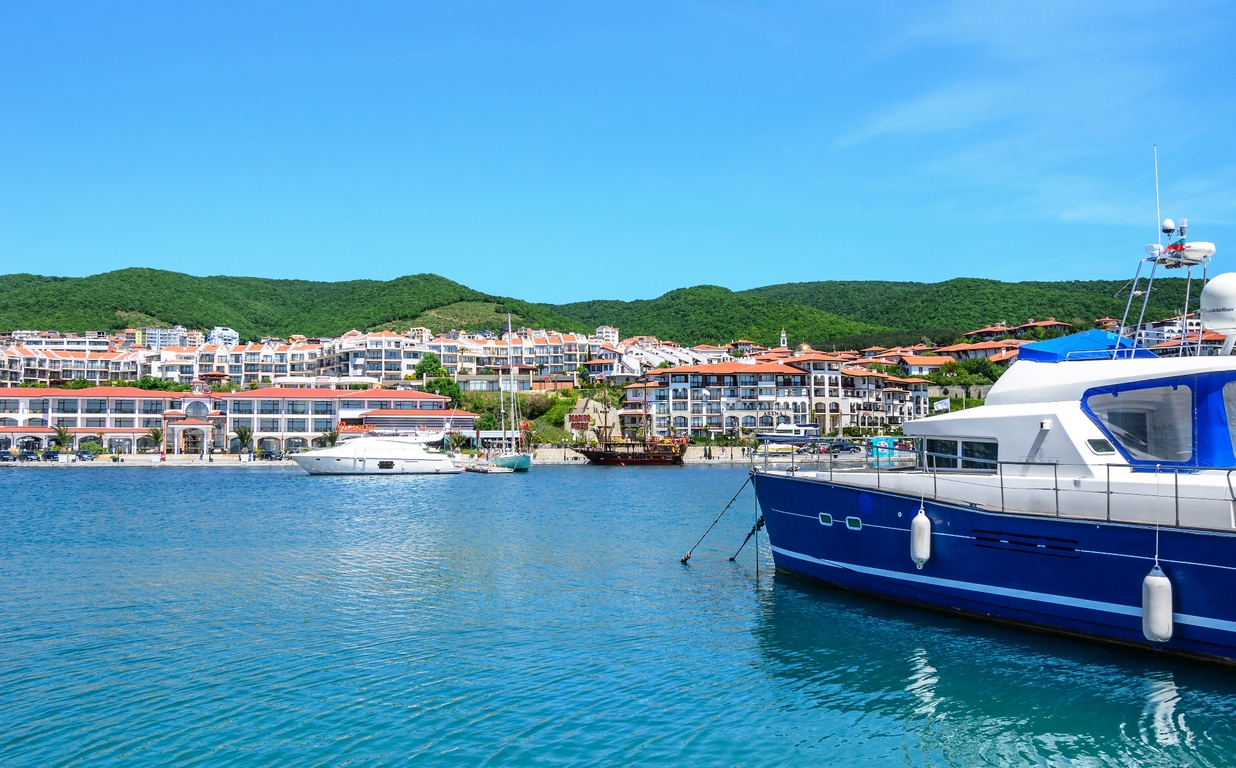 Marina harbor view with boats and coastal town